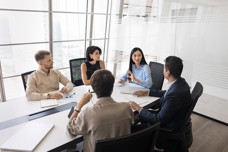 Young,Female,Asian,Business,Leader,Holding,Meeting,With,Diverse,Team